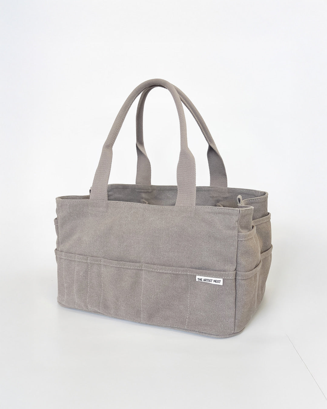 Paperbark light brown Artist Bag diagonal view, canvas artist supply bag with multiple exterior pockets and tall interior pockets for makers in Australia.