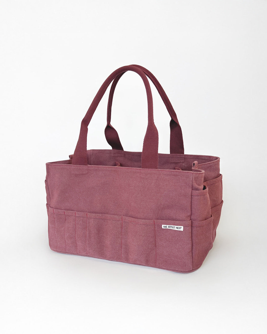 Waratah red Artist Bag diagonal view, canvas artist supply bag with exterior pockets and tall interior pockets for creatives in Australia.