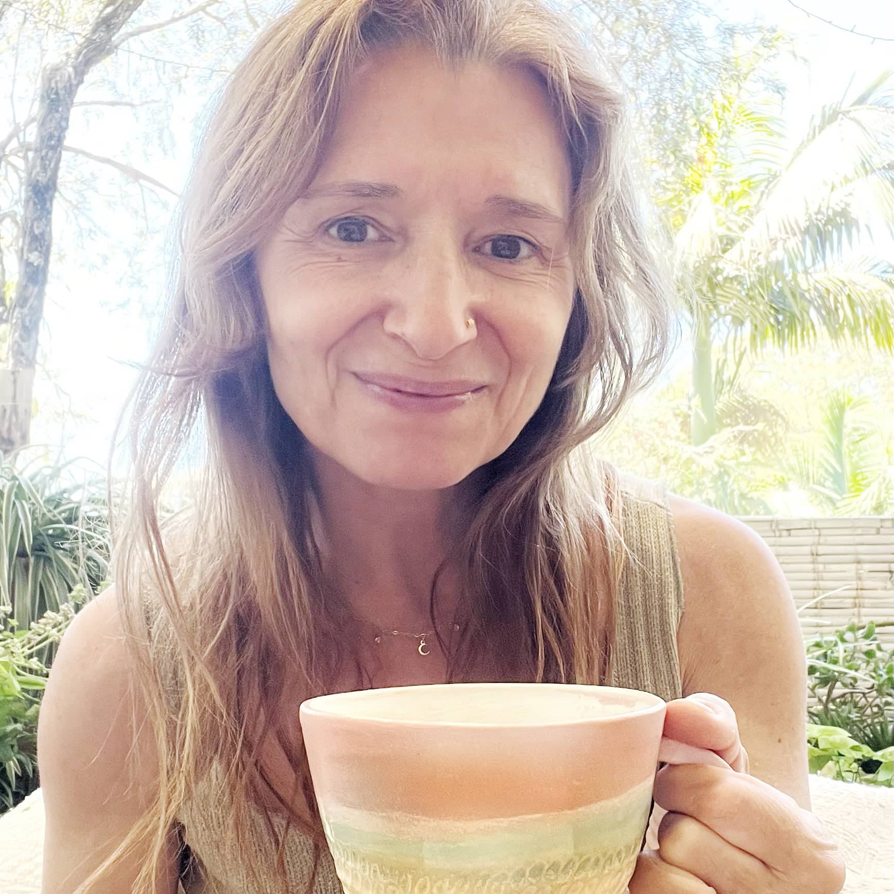 Portrait of Mon Manabu, founder of The Artist Nest, holding a handmade ceramic cup created by her in Northern Rivers 2025.