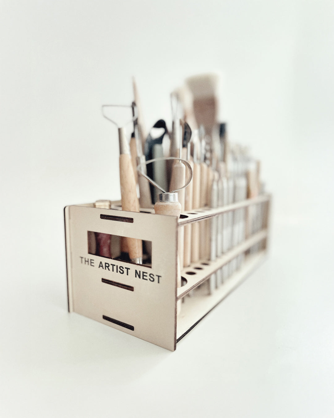 Side view of the wooden pottery tool rack fully loaded with pottery tools, showing its organised and practical design.