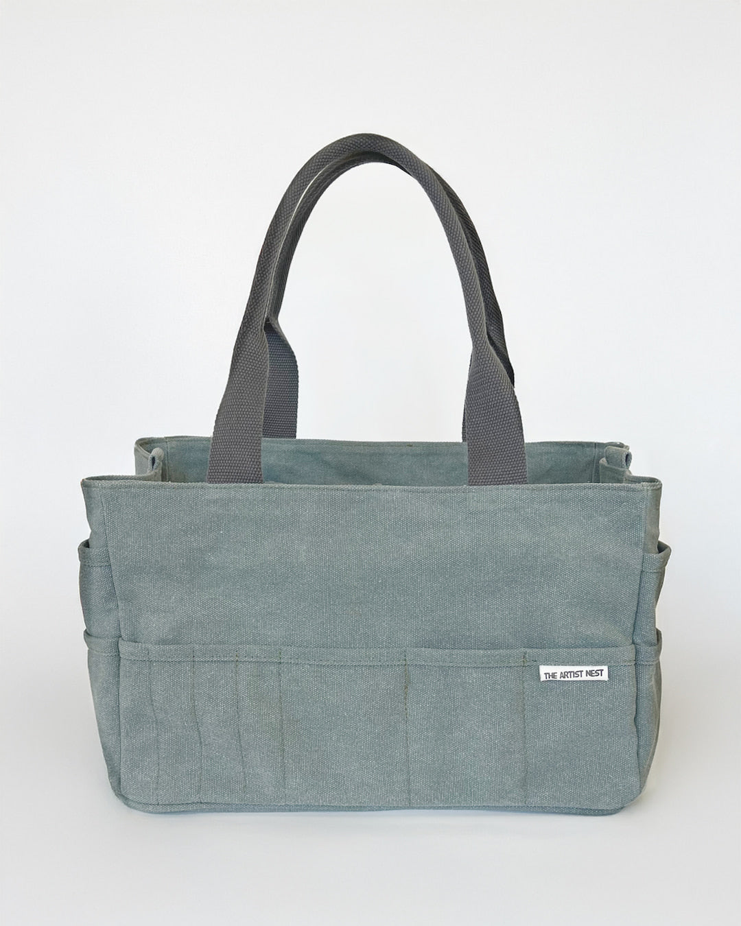 Front view of the Eucalypt green art supply tote bag featuring canvas material, reinforced structure and a multi pocket layout ideal for artists and makers in Australia.