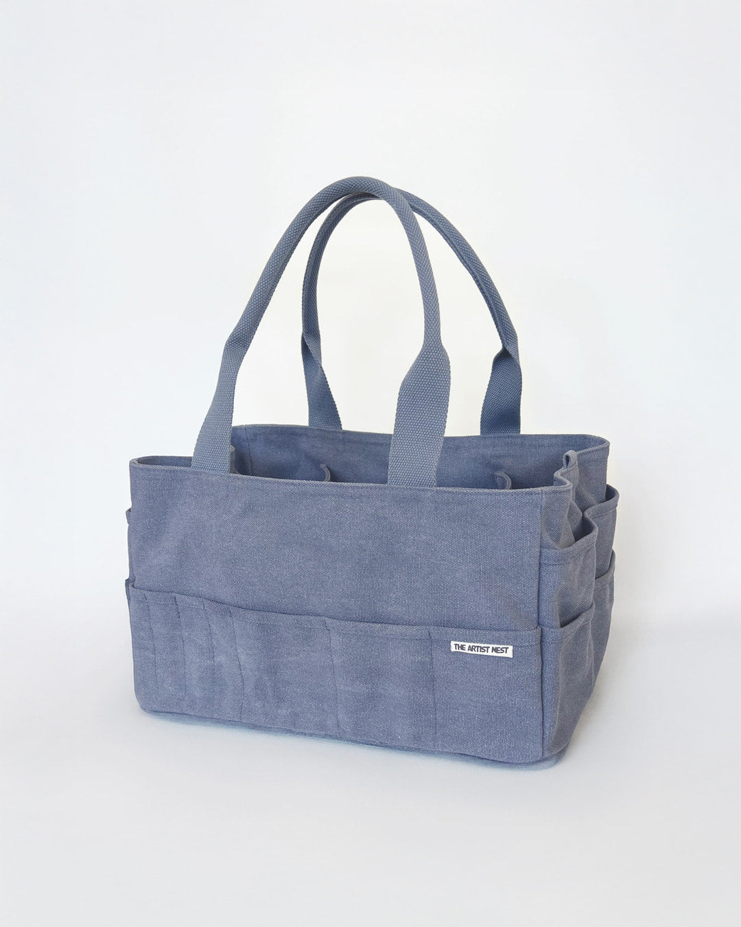 The Pass blue Artist Bag in a diagonal view, multi pockets pottery tool bag with 18 exterior & nine tall interior pockets, designed for artists in Australia